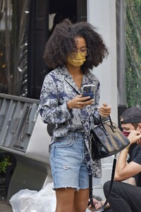 yara-shahidi-in-a-printed-top-denim-shorts-and-white-sneakers-new-york-09-12-2021-3.jpeg