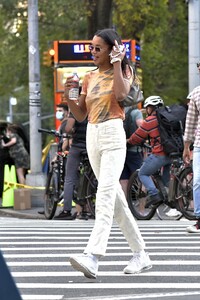 laura-harrier-in-a-tie-die-shirt-and-off-white-pants-and-white-sneakers-new-york-09-12-2021-5.jpg
