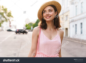 stock-photo-photo-of-brunette-young-woman-wearing-summer-dress-and-straw-hat-smiling-while-walking-on-city-1454396150.jpg