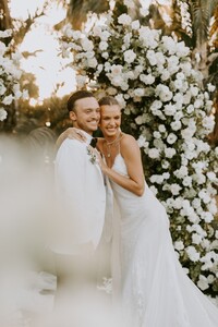 Credit_Courtney%20Pecorino%20-%20The%20bride%20and%20groom%20smile%20for%20the%20camera%20after%20the%20ceremony.%20Florals%20by%20Christina%20G..jpg