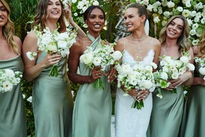 Credit_Dan%20Martensen%20-%20The%20bride%20with%20her%20bridesmaids,%20wearing%20Mumu%20dresses%20in%20sage%20green.%20Florals%20by%20Christina%20G..jpeg