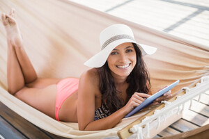 pretty-brunette-relaxing-hammock-using-tablet-pc.jpg