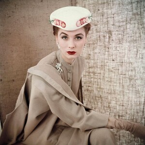 25 Clifford Coffin, Suzy Parker wearing beige button-front suit with white flower hat by Christian Dior, march 1953.jpg