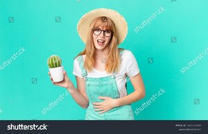 stock-photo-pretty-red-head-woman-laughing-out-loud-at-some-hilarious-joke-and-holding-a-potted-cactus-farmer-2100708844.jpg