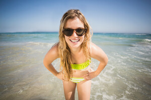 21724864_portrait-of-happy-woman-standing-on-the-beach.jpg