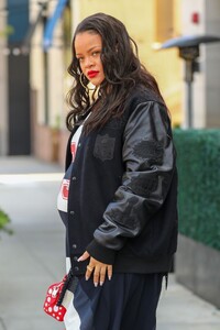 rihanna-in-varsity-jacket-puma-sneakers-and-a-bright-red-louis-vuitton-bag-in-los-angeles-06-16-2023-0.jpg