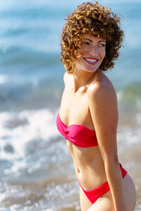 52603166_graceful-happy-lady-standing-on-seashore-and-smiling.jpg
