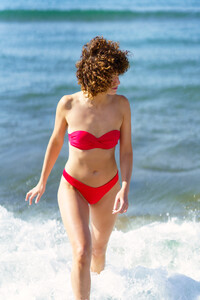 53055376_female-in-swimwear-walking-in-ocean-water-at-beach.jpg