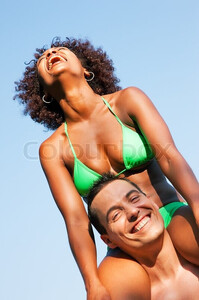 8684156-summer-bikini-girl-sitting-on-shoulders-of-man.jpg