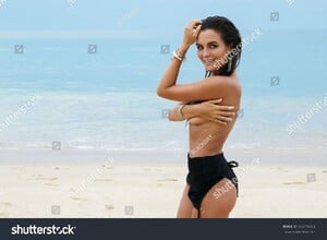 stock-photo-beautiful-and-sexy-woman-on-the-beach-wearing-silver-jewelry-592776956.jpg