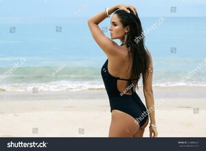 stock-photo-beautiful-and-sexy-woman-on-the-beach-wearing-silver-jewelry-654008287.jpg