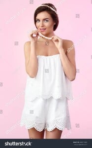 stock-photo-beautiful-and-tender-woman-in-jumpsuit-with-a-small-marshmallow-beads-430015969.jpg