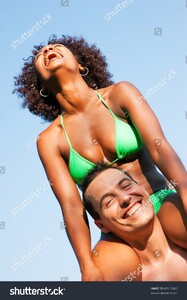 stock-photo-couple-in-love-woman-of-brazilian-origin-in-bikini-sitting-on-her-man-s-shoulders-under-blue-sky-45913963.jpg