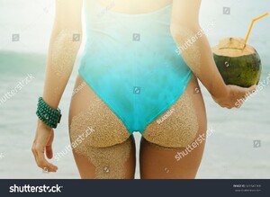 stock-photo-female-buttocks-and-coconut-drink-on-the-beach-661547068.jpg