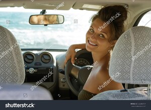 stock-photo-happy-female-driver-with-a-beautiful-smile-is-sitting-in-the-car-556303171.jpg