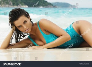 stock-photo-portrait-of-beautiful-and-sexy-woman-in-blue-swimsuit-on-the-beach-661547506.jpg
