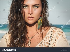 stock-photo-portrait-of-woman-wearing-a-wooden-pendant-and-feather-earrings-404519761.jpg