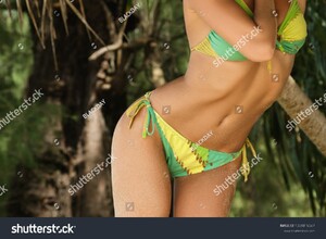 stock-photo-sexy-and-beautiful-woman-wearing-green-bikini-in-the-jungles-1039816687.jpg