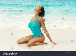 stock-photo-sexy-and-wet-woman-in-blue-swimsuit-on-the-beautiful-white-sand-beach-661548118.jpg