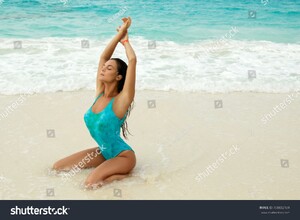 stock-photo-sexy-and-wet-woman-in-blue-swimsuit-on-the-beautiful-white-sand-beach-708832189.jpg