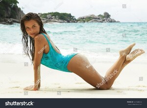 stock-photo-sexy-woman-in-blue-swimsuit-covered-with-sand-on-the-beach-661548856.jpg