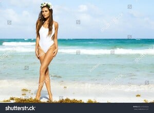stock-photo-sexy-woman-in-white-swimsuit-is-posing-on-the-beach-661553266.jpg