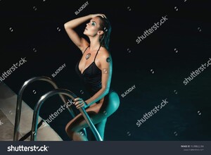 stock-photo-sexy-woman-wearing-black-swimsuit-in-the-pool-at-night-1039822504.jpg