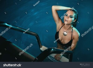 stock-photo-sexy-woman-wearing-black-swimsuit-in-the-pool-at-night-1039822525.jpg