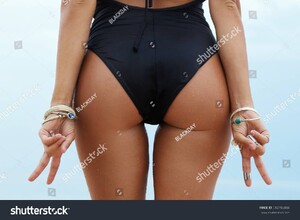 stock-photo-woman-with-sexy-booty-is-showing-victory-or-peace-gesture-592788404.jpg
