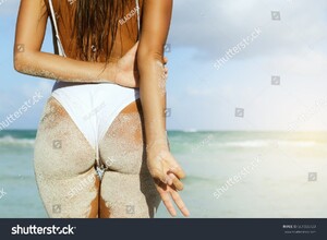 stock-photo-woman-with-sexy-buttocks-on-the-beach-661555723.jpg