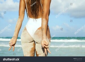 stock-photo-woman-with-sexy-buttocks-on-the-beach-661555750.jpg