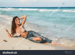 stock-photo-young-charming-woman-in-wet-jeans-on-the-beach-404524219.jpg