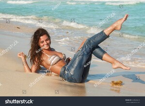 stock-photo-young-charming-woman-in-wet-jeans-on-the-beach-404524255.jpg