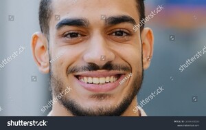 stock-photo-close-up-outdoors-head-male-portrait-young-hispanic-happy-smiling-handsome-business-man-standing-in-2089561180.jpg