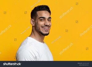 stock-photo-portrait-of-cheerful-stylish-handsome-bearded-middle-eastern-young-man-in-white-t-shirt-posing-on-2107825811.jpg