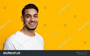 stock-photo-portrait-of-cheerful-stylish-handsome-bearded-middle-eastern-young-man-in-white-t-shirt-posing-on-2138369169.jpg