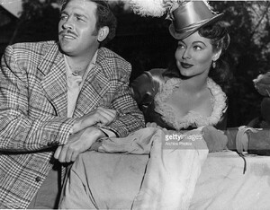Howard Keel and Ava Gardner watch others in a scene from the film___.jpg