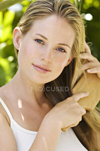 focused_222641310-stock-photo-portrait-young-woman-brushing-hair.jpg