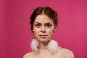 woman-bare-shoulders-fluffy-earrings-bright-makeup-pink-background_163305-108617.jpg