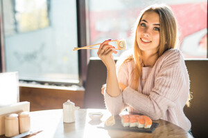 girl-white-sweater-eating-sushi-lunch-small-caffe (1).jpg