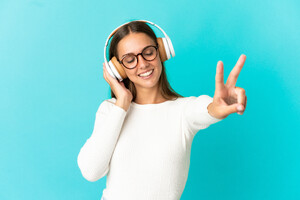 young-woman-isolated-blue-background-listening-music-singing.jpg
