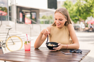 close-up-young-attractive-woman-eating-salad-street-cafe (2).jpg