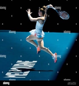 tennis-player-maria-sakkari-hits-a-forehand-as-she-jumps-back-over-the-melbourne-logo-2HR4R1A.jpg